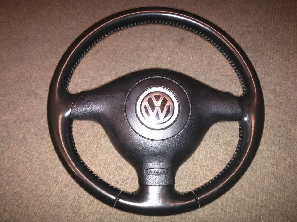 Black steering wheel with Volkswagen logo and AIRBAG text