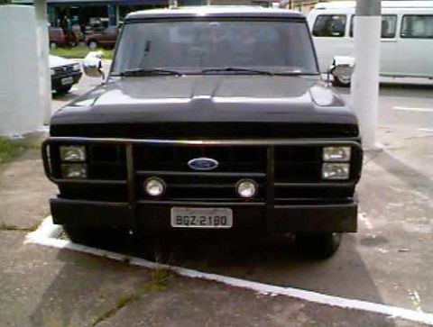 1970 Ford F-100 - This black Ford truck is shown from the front, a prominent grille guard and license plate BGZ-2180.