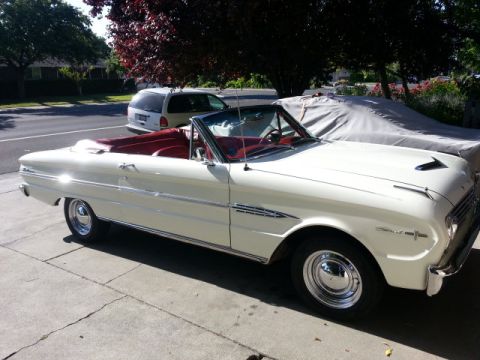 1963 Ford Falcon - White 1963 Ford Falcon convertible with a red interior is parked on a concrete driveway.