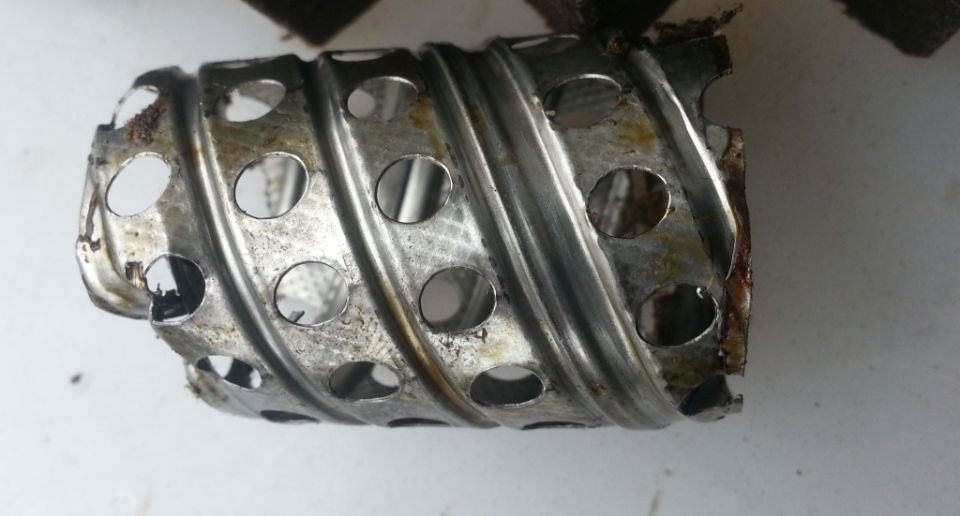Damaged oil filter cage with holes