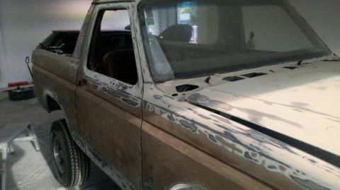 1982 Ford Bronco - Bodywork in progress on a 1982 Ford Bronco, showing filler on the exterior panels.