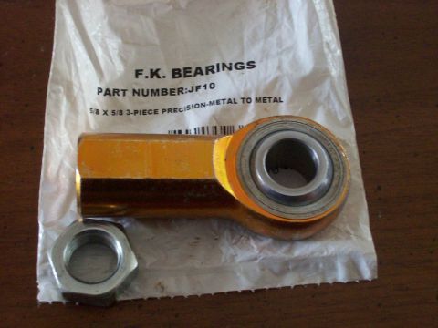 1982 Ford F-100 - A yellow rod end bearing and a silver nut are shown on a white plastic bag with text.