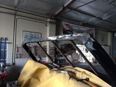 1992 Ford Bronco - The roof of a vehicle is being modified in a workshop setting.