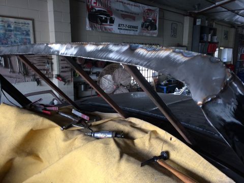 1992 Ford Bronco - Metal fabrication tools and clamps are laid out on a yellow tarp during a roof chop modification.