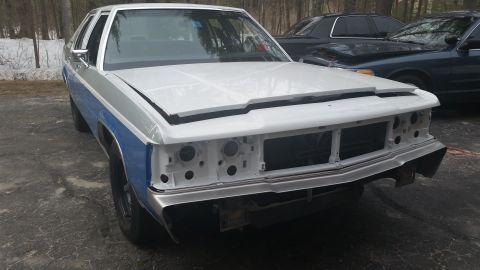 1991 Ford LTD Crown Victoria - Front view of a Ford Crown Victoria undergoing restoration, with another vehicle in the background.