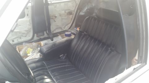 1991 Ford LTD Crown Victoria - Interior view of a car showing black seats and disassembled door panels, suggesting a project in progress.