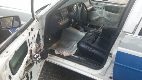 1991 Ford LTD Crown Victoria - Interior view of a 1991 Ford Crown Victoria LTD with the driver's side door panel removed for work.