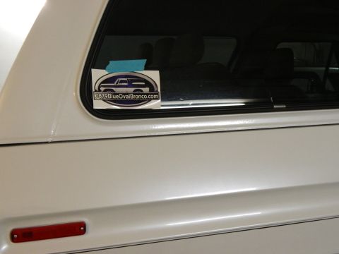 1979 Ford Bronco - A sticker on a white vehicle indicates it is a 1979 Ford Bronco.