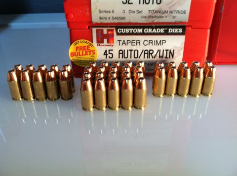 1976 Dodge Power Ram - Reloading dies and cartridges are displayed on a white surface.