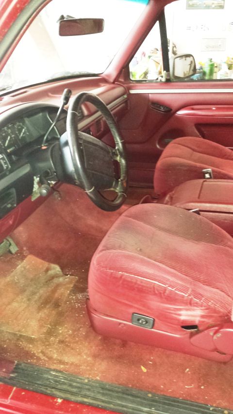 2001 Ford F-150 - Interior view of a red 1994 Ford Bronco, showing the seats, dashboard, and steering wheel.