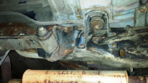 2001 Ford F-150 - Close-up view of the rusted undercarriage and exhaust system of a vehicle.