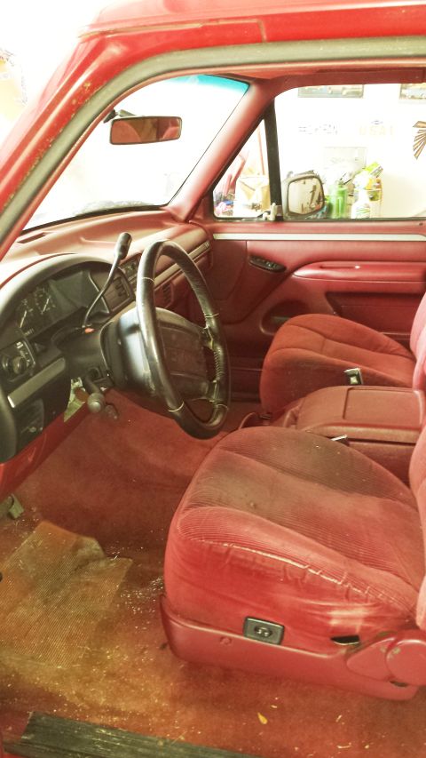 2001 Ford F-150 - Interior view of a red truck, showing the seats, dashboard, and steering wheel.