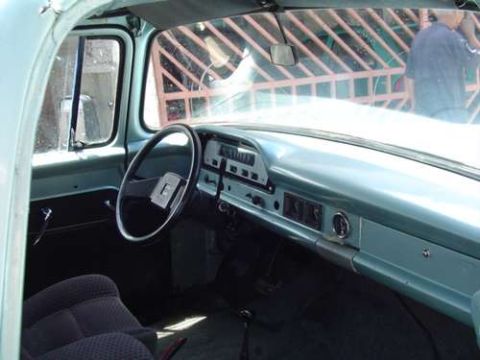 1970 Ford F-100 - The interior of a light blue truck from the 1960s, a classic dashboard and steering wheel.