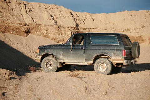 1987 Ford Bronco - This 1987 Ford Bronco is seen off-road in a sandy, hilly environment.