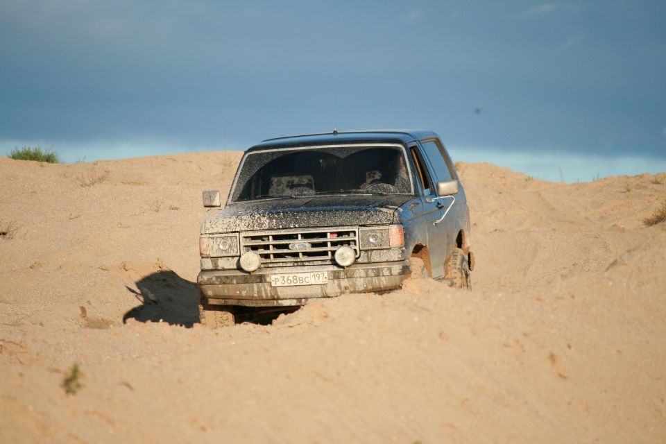 1987 Ford Bronco stuck in sand, front view