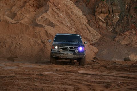 1987 Ford Bronco - This 1987 Ford Bronco is navigating a sandy, off-road terrain.