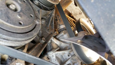 1990 Ford Bronco - This image shows a close-up view of the engine's serpentine belt system and associated pulleys.