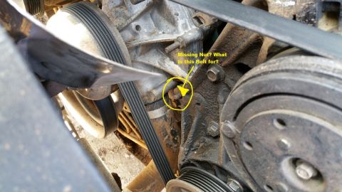 1990 Ford Bronco - Close-up of an engine component showing a missing nut and bolt, with a question about its purpose.