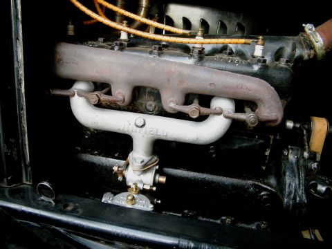 1915 Ford Model T - This photo shows an engine, specifically highlighting a Winfield carburetor and exhaust system, not the entire vehicle.