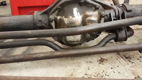 1978 Ford Bronco - Close-up view of a vehicle's rear axle differential and associated suspension parts.