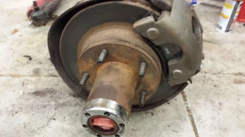 1978 Ford Bronco - Close-up of a worn front wheel brake assembly, showing rust and a visible brake caliper.