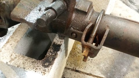 1978 Ford Bronco - Close-up of a rusty metal component, possibly from a vehicle's drivetrain, a U-bolt clamp and a Supermotors.net watermark.