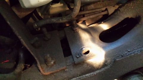 1978 Ford Bronco - Undercarriage view of a vehicle's frame and suspension parts, showing signs of rust and wear.