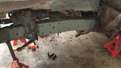1978 Ford Bronco - Undercarriage of a vehicle, showing frame and suspension parts, supported by jack stands.