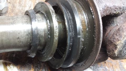 1978 Ford Bronco - Close-up view of a worn metal shaft with seals, likely a component from a vehicle's drivetrain.