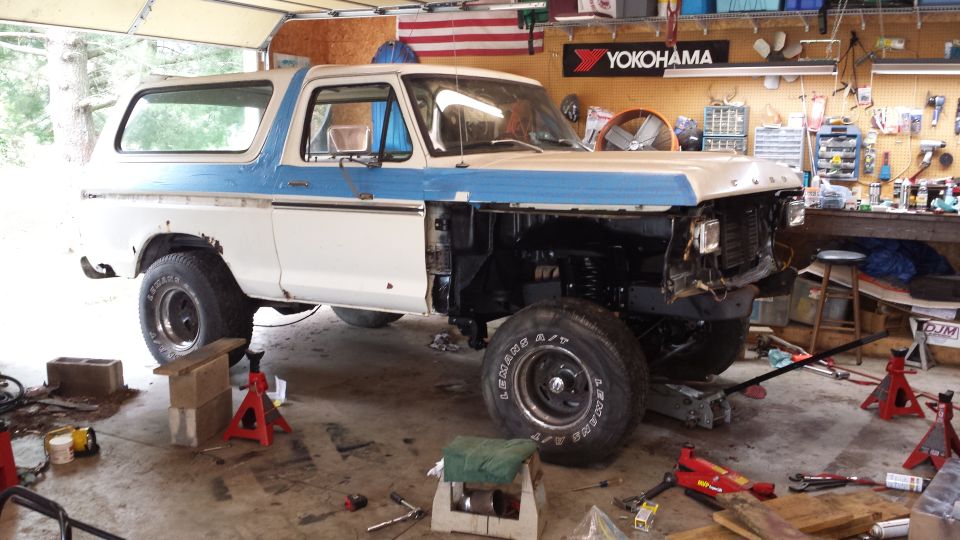 1978 Ford Bronco in garage, front end disassembled, hood removed, on jack stands