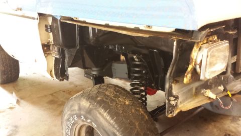 1978 Ford Bronco - Front fender and suspension of a 1978 Ford Bronco undergoing repairs. The SuperMotors.net logo is visible in the lower right corner.