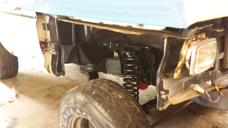 1978 Ford Bronco front fender and suspension during repair. SuperMotors.net logo visible