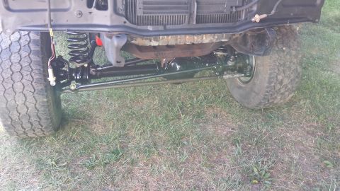 1978 Ford Bronco - Front suspension and tires of a 1978 Ford Bronco, showing off its off-road capabilities.