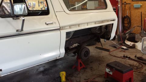 1978 Ford Bronco - 1978 Ford Bronco undergoing repairs in a garage, rear axle removed.