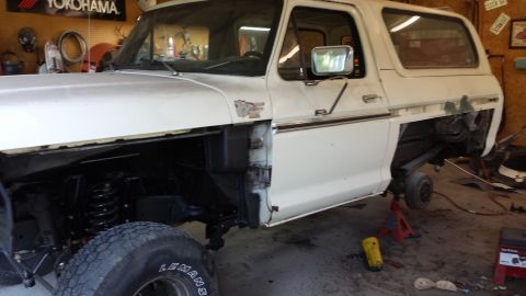 1978 Ford Bronco - This 1978 Ford Bronco is in a garage, with its front fender removed and supported by jack stands.