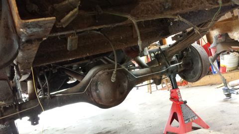 1978 Ford Bronco - Undercarriage view of a 1978 Ford Bronco, showing the rear differential and leaf spring suspension system.