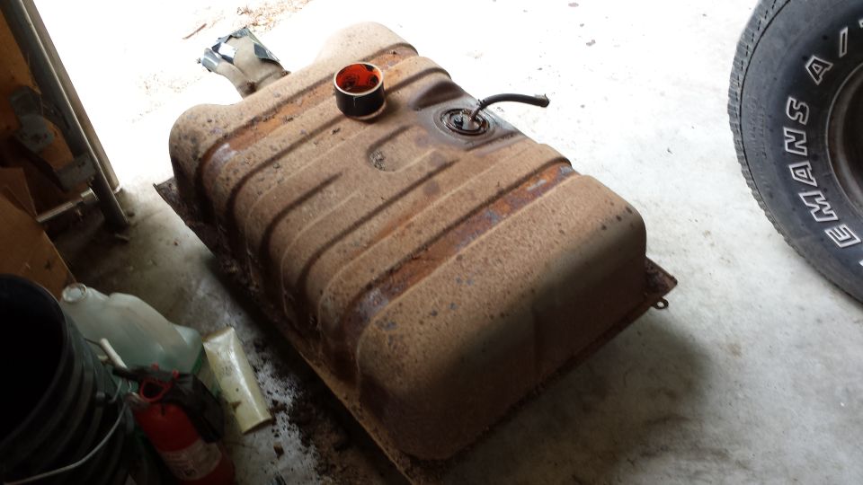 Rusted vehicle fuel tank with filler neck and fuel line attached