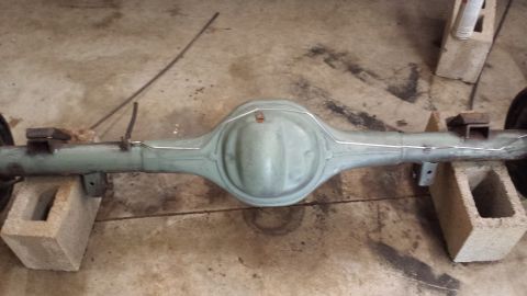 1978 Ford Bronco - Rear axle assembly, likely from a truck or SUV, is supported by concrete blocks.