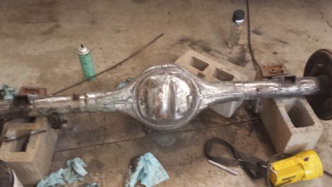 1978 Ford Bronco - A rear axle assembly is shown resting on cinder blocks in a garage setting.