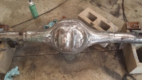 1978 Ford Bronco - Rear axle assembly shown during a restoration process, resting on concrete blocks.