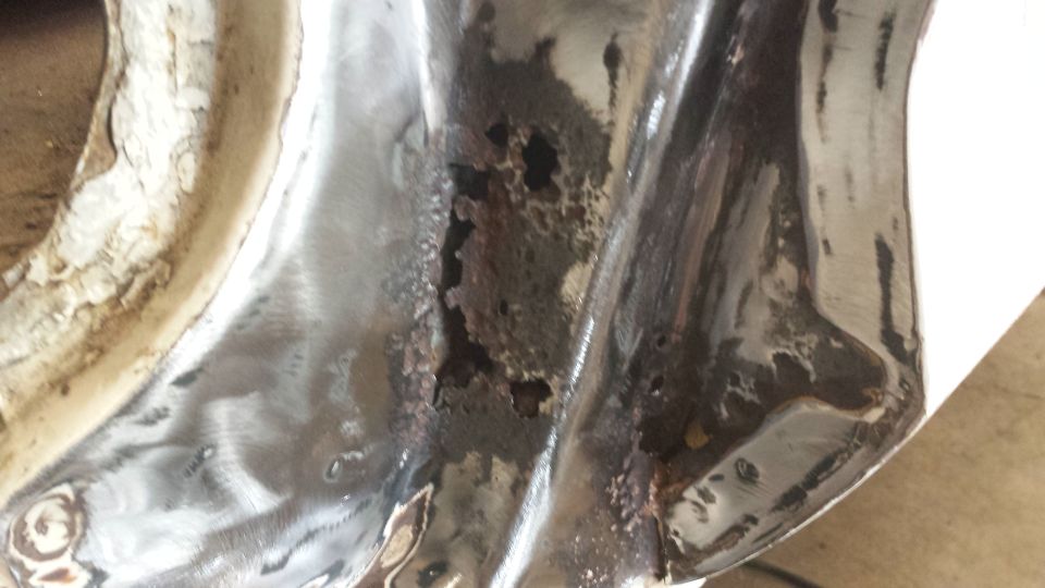 Close-up of rusted metal panel with visible holes
