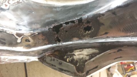 1978 Ford Bronco - This image shows significant rust damage on a metal car part, indicating structural compromise.