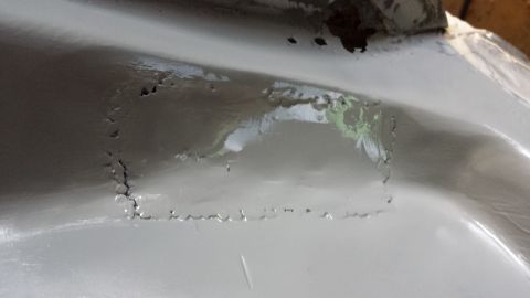 1978 Ford Bronco - This image shows a section of a vehicle's body with significant rust damage and pitting.
