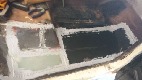 1978 Ford Bronco - The interior floor of a 1978 Ford Bronco shows areas patched with white sealant.