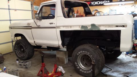 1978 Ford Bronco - This 1978 Ford Bronco is in a garage, elevated on jack stands for maintenance or repair work.