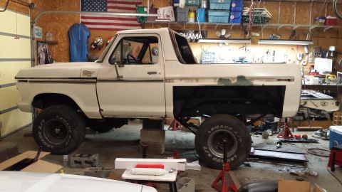 1978 Ford Bronco - This 1978 Ford Bronco is being worked on in a garage, supported by jack stands.
