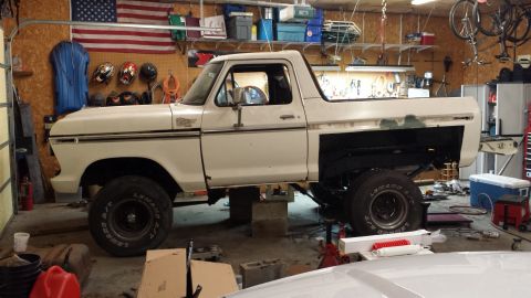 1978 Ford Bronco - This 1978 Ford Bronco is undergoing some work in a cluttered garage setting.