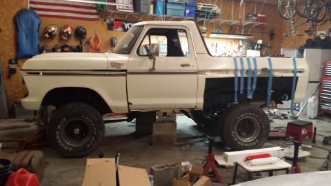1978 Ford Bronco - This 1978 Ford Bronco is shown in a garage, lifted on blocks and appearing to be in the process of repair or modification.