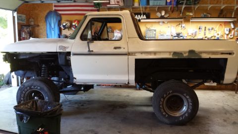 1978 Ford Bronco - This 1978 Ford Bronco is undergoing restoration in a garage, with its front end partially disassembled.