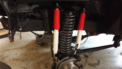 1978 Ford Bronco - The front suspension of a vehicle is shown with new shocks and springs installed.